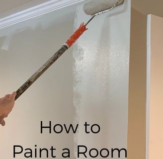 a person painting a room with a paint roller