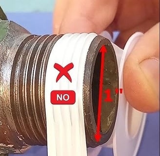 a person holding a pipe with a pipe sticking out of it