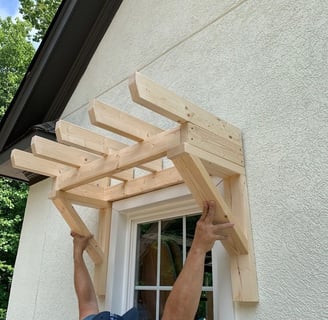 a man is holding a wooden structure in his hands