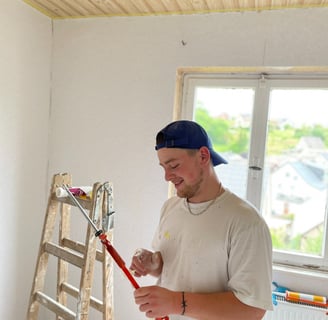 a man in a white shirt and a ladder