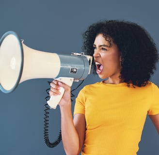 a woman with a yellow shirt and a megaphone