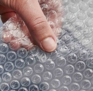 a person holding a piece of bubble bubble wrap