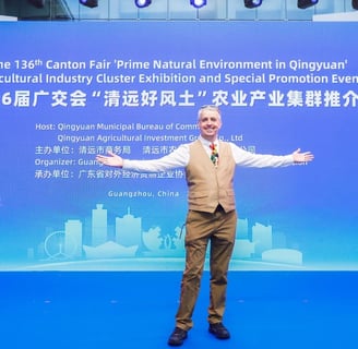 a man standing in front of a banner that says, the man is holding a