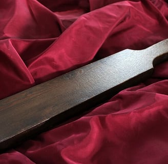 a wooden cutting board spanking paddle
