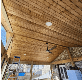 a ceiling fan with a ceiling wood, framing