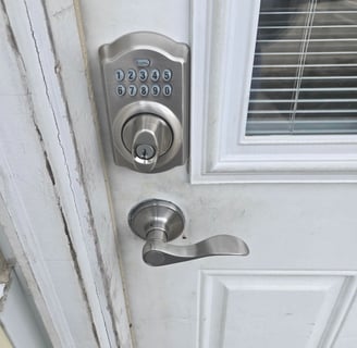 A white door with a keypad lock representing Jack’s Locksmith local keypad door lock services