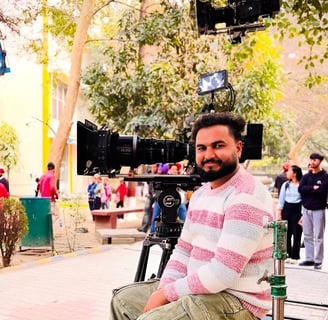 sukhvinder singh sitting on a bench in front of a camera