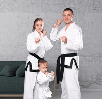 a man and woman in karate gear posing for a photo