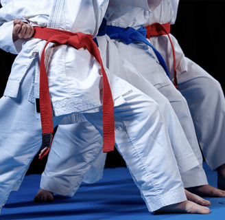a group of people standing on a blue mat
