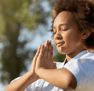 a woman in a white shirt is holding her hands together
