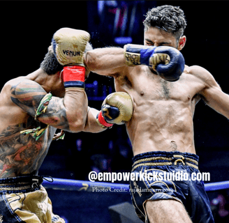 a man in a boxing ring with a tattoo on his arm