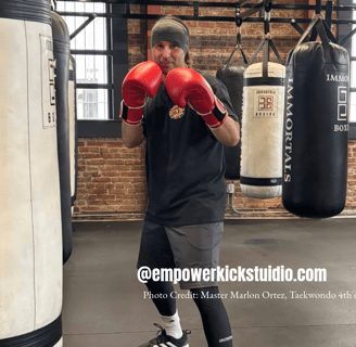 a man in a black shirt and red boxing gloves