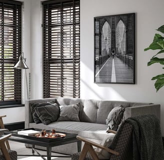 Black and white architectural photograph displayed above a modern sofa