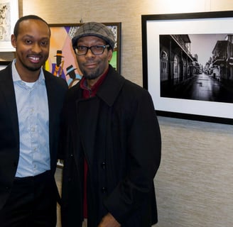 photographer Gary Washington and Will Clarke standing next to bourbon st artwork