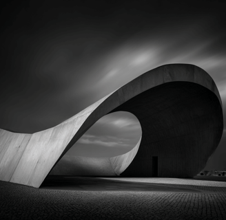 Curved concrete structure in dramatic black and white.