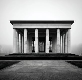 Foggy neoclassical building with tall columns.