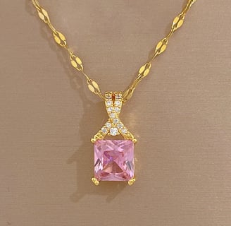 a pink princess cut diamond necklace with a pink and gold necklace