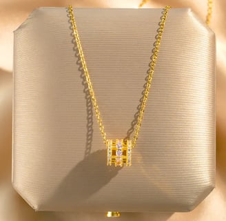 a necklace with a diamond and a gold necklace