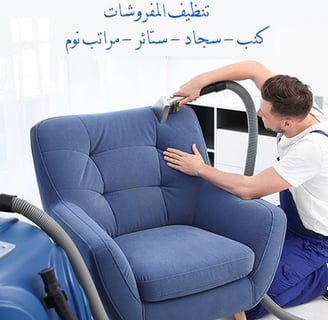 a man is cleaning a blue chair in a living room