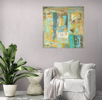 Wall art in ochre and turquoise in lounge chair setting with palm tree