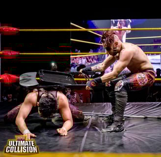 The British Horror pounds Khoa Truong with a chair during the Devil's Playground match