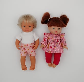 Miniland and Minikane dolls dressed in pink handmade outfits