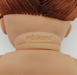 Minikane stamp on the back of a dolls neck