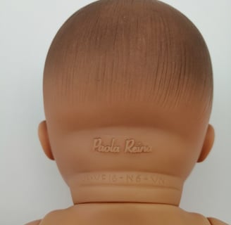 Paola Reina embossed on the back of a dolls neck