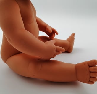 Miniland doll sitting