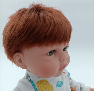 Boy doll with green eyes and red hair