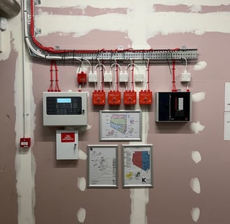 a room with a wall mounted with electrical equipment