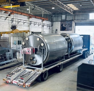 a train car being loaded with a tank