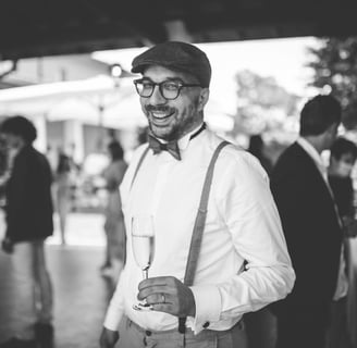 a man in a suit and bow tie smiling
