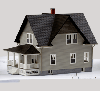 imagem de uma casa em miniatura em cima de um projeto em papel