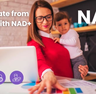 Woman working on a laptop while holding her baby, symbolizing energy, focus, and balance. The image 
