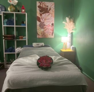 Serene treatment room at Ashburton Thai Massage & Spa featuring a comfortable massage bed, soft ligh