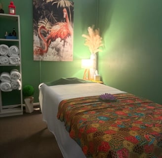 Tranquil Thai-style massage room at Ashburton Thai Massage & Spa with soft lighting, comfortable massage bed, and traditional