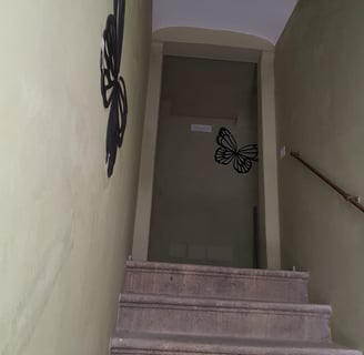 a stairway way with a butterfly on the wall