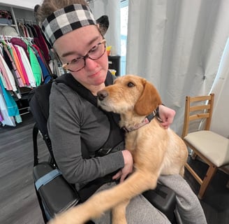 a woman in a wheelchair with a dog in a wheelchair