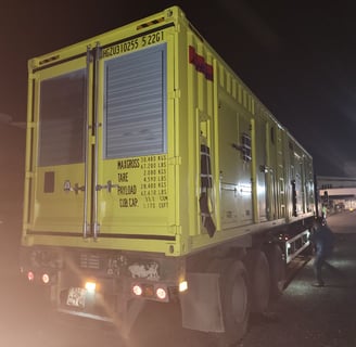 a truck with a yellow trailer parked on the side of the road