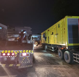 a truck with a yellow box sitting on the side of a road