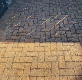 outdoor cleaning services Fife - a yellowish orange bricked driveway, half clean, half dirty