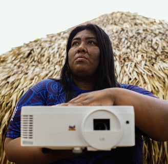 a woman holding a projector and a projector