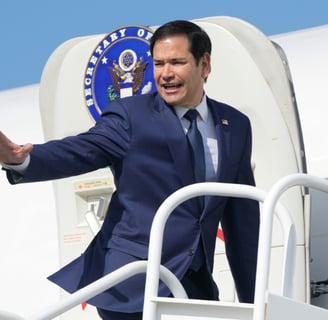 a man in a suit and tie is walking up stairs