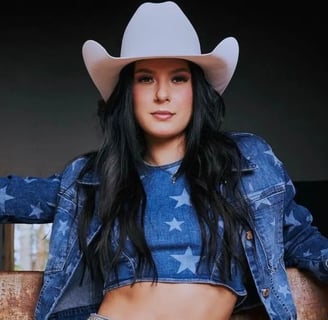 a woman in a cowboy hat and jeans ana castela