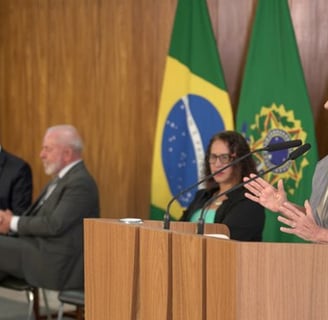 a woman in a suit and tie is standing at a podium