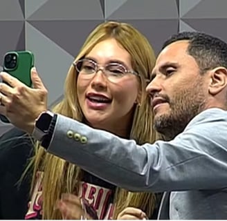a man and woman taking a selfie with a green phone