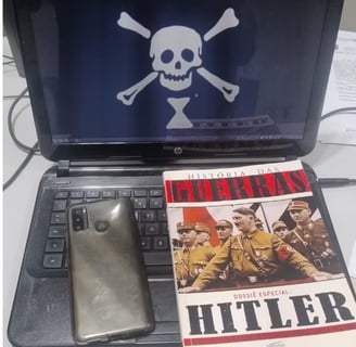 a laptop computer sitting on a desk with a book and a book