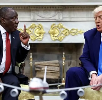 a man in a suit and tie is sitting in a chair