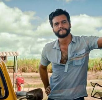 a man standing next to a yellow car